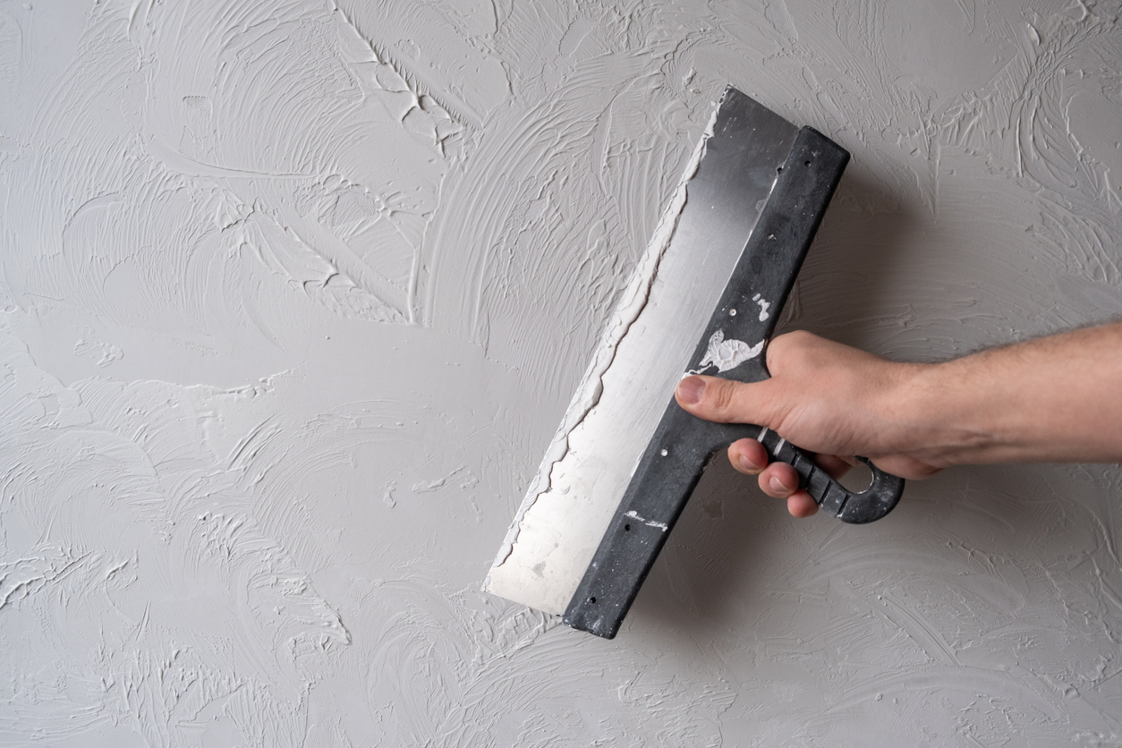Applying decorative putty on a home in Vallejo