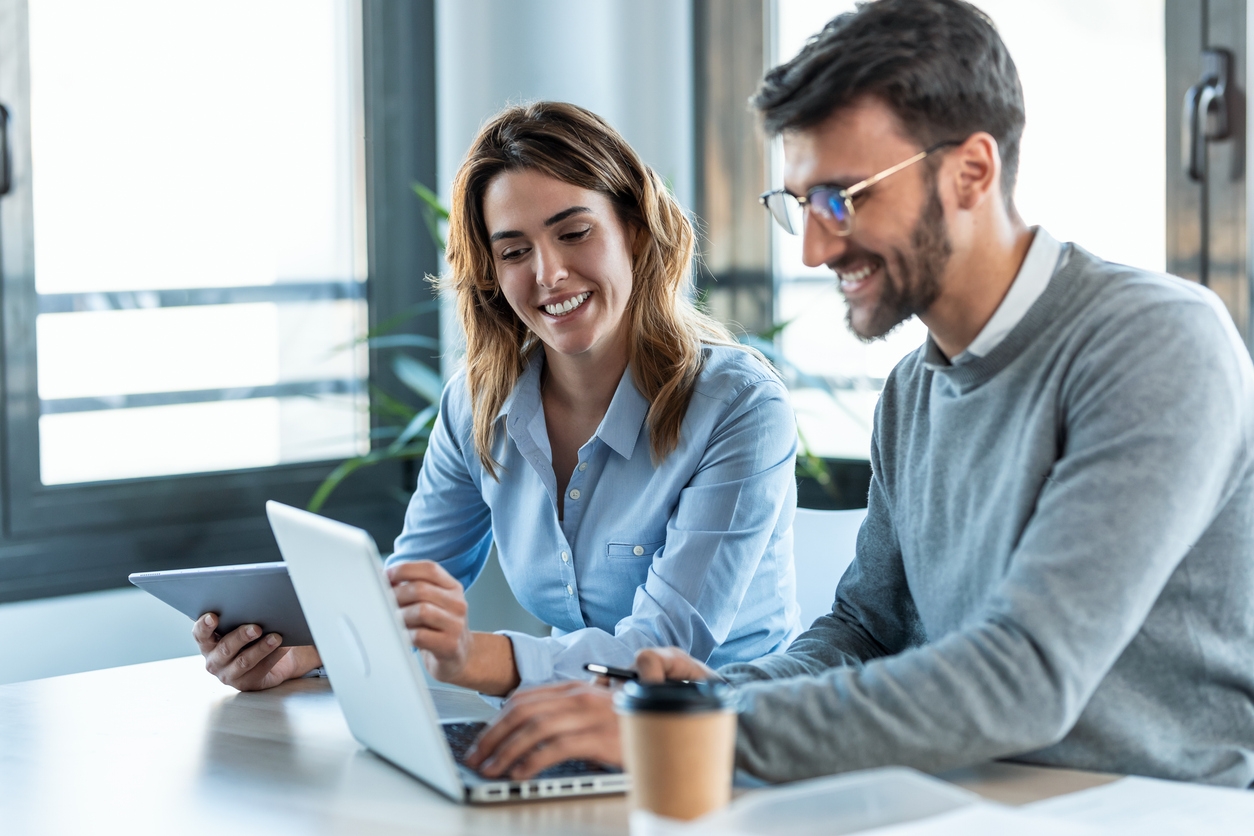 Smart business people working with plans while talking of their new design business
